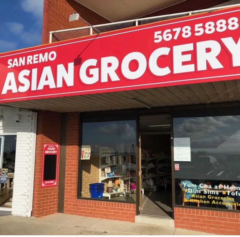 San Remo Asian Grocery shopfront with large red sign and promotional window graphics in daylight
